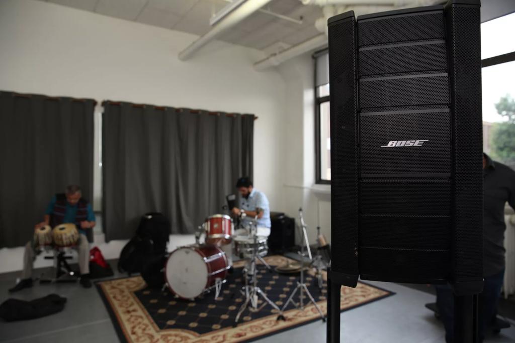 Bose F1 Model 812 powered loudspeaker (foreground), set up for Microsessions in Brooklyn, while Salsa Masala sets up in background. Photo by Erick Das Chagas. © 2019.