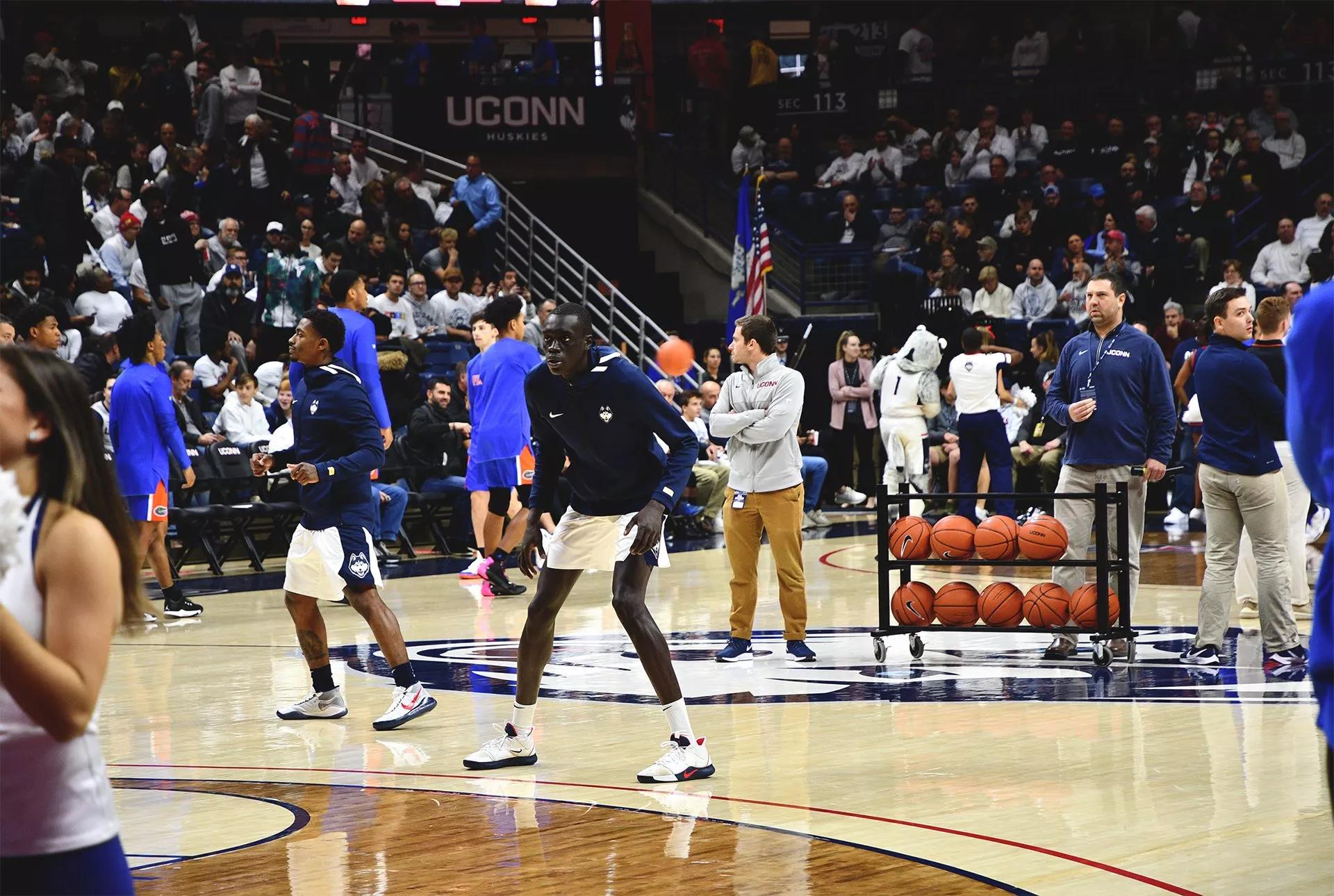 People on the basketball court at Gampel Pavilion