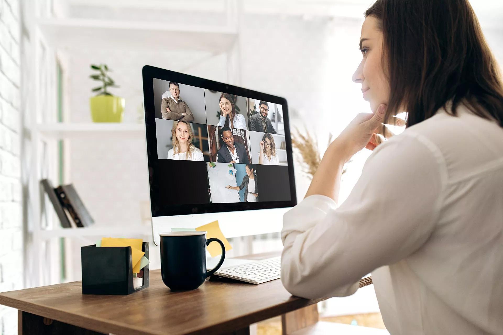 A woman working from home collaborates in an online conference call.