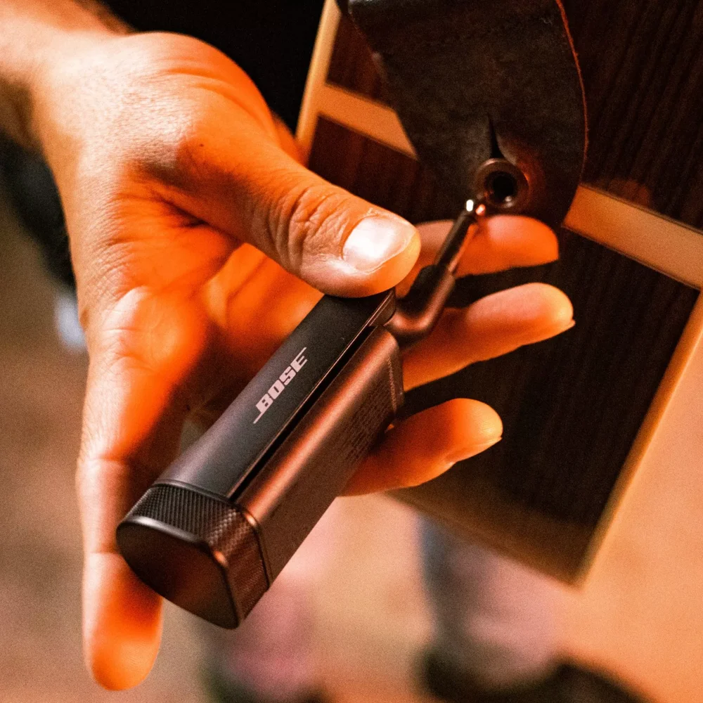 Closer image of musician attaching the transmitter