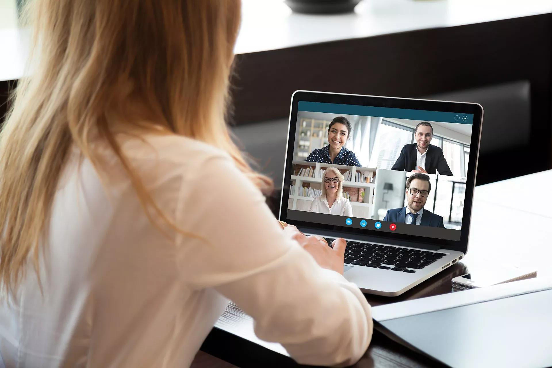 An executive working in the field connects with colleagues through videoconference