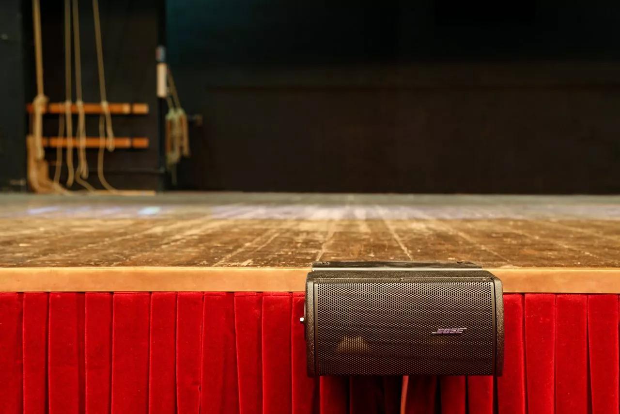 RoomMatch Utility RMU105 loudspeaker mounted to the front of the stage