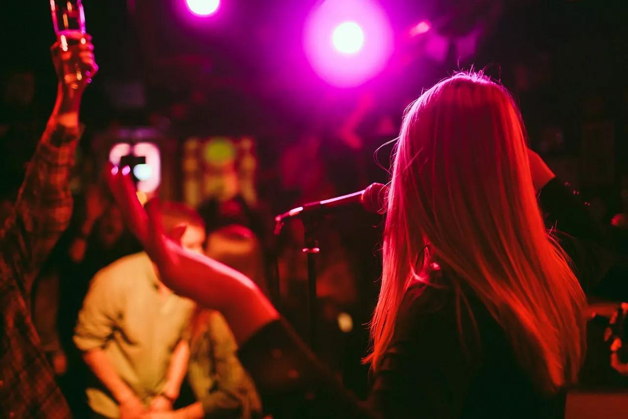 Person speaking into a microphone to an audience