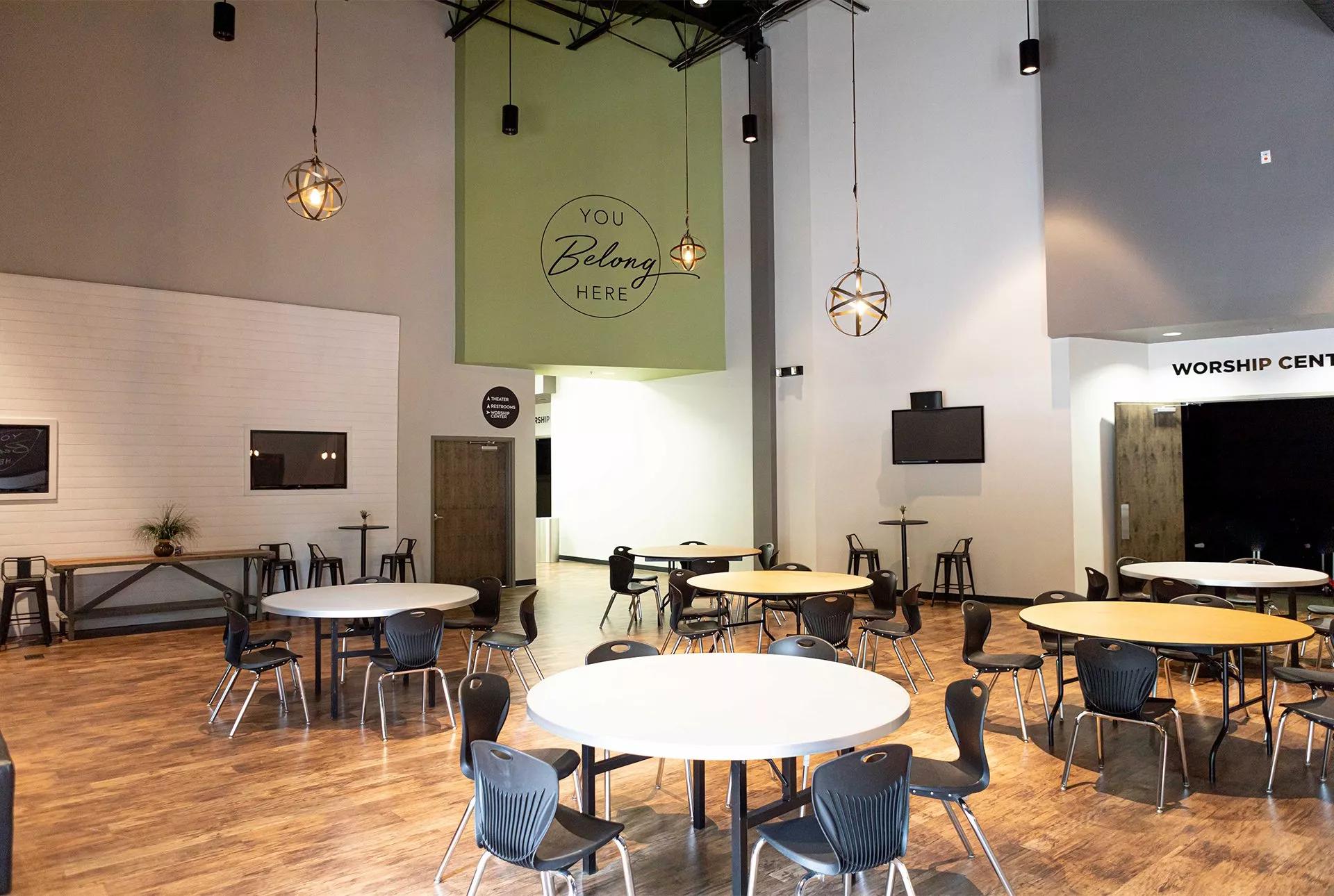 Interior gathering room with tables and chairs